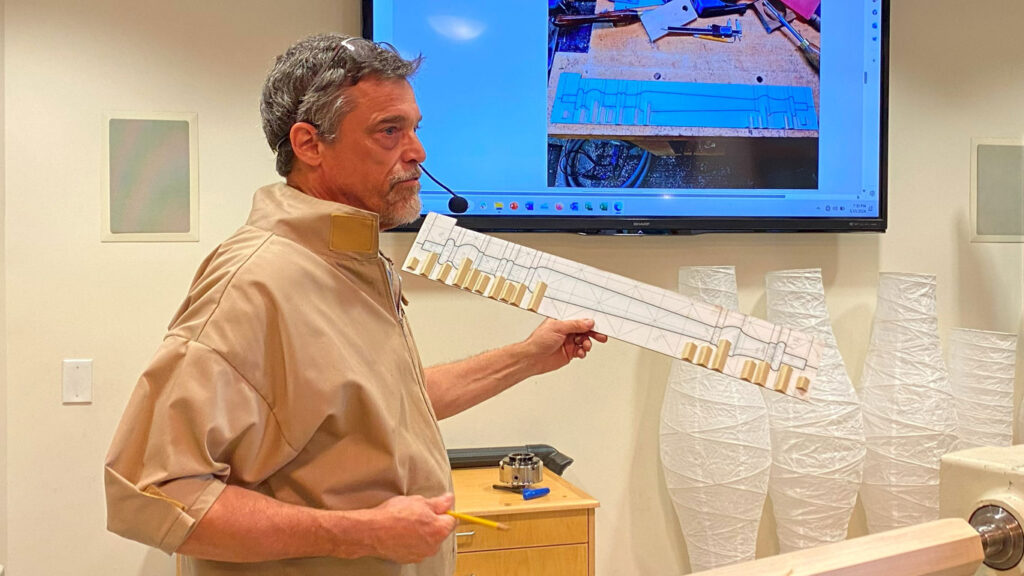 Claude talks about spindle turning patterns and how he glued small pieces to the pattern to calibrate calipers.