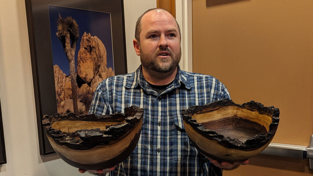 Nate Segraves is holding two Walnut bowls