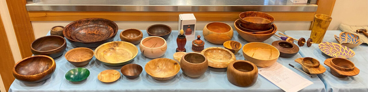 Show & Tell Woodturning Projects placed on the table. Mostly bowls, platters, and vases. Shared as part of Woodturners Newsletter.