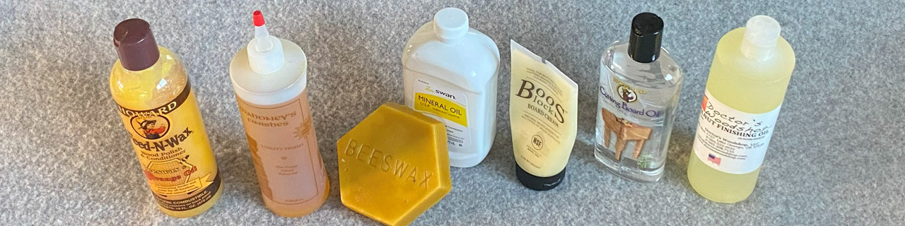 Several bottles of various food-safe finish and a bar of beeswax.