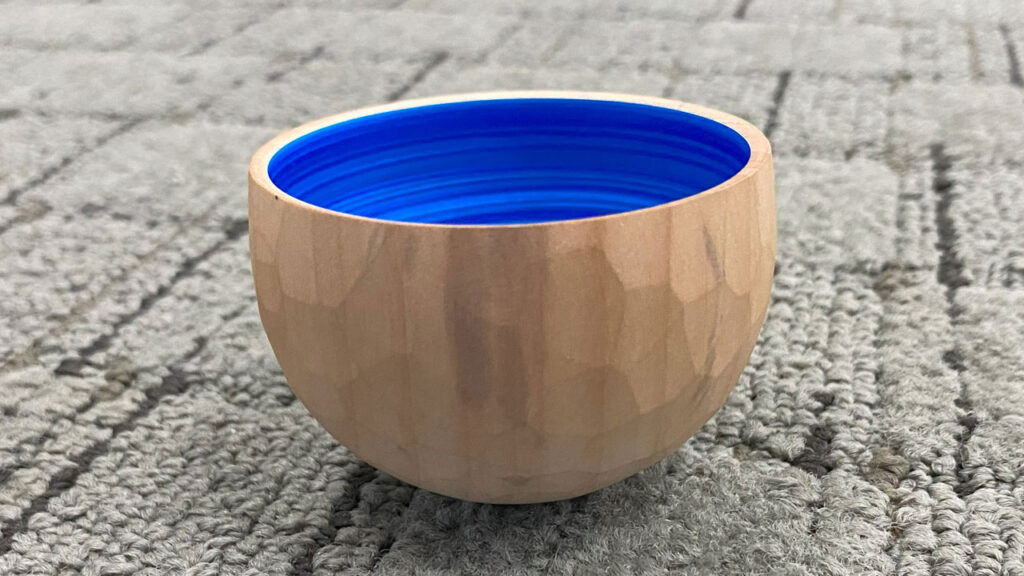 Namaste bowl with faceted walls outside and blue spiral inside by Eric Lofstrom