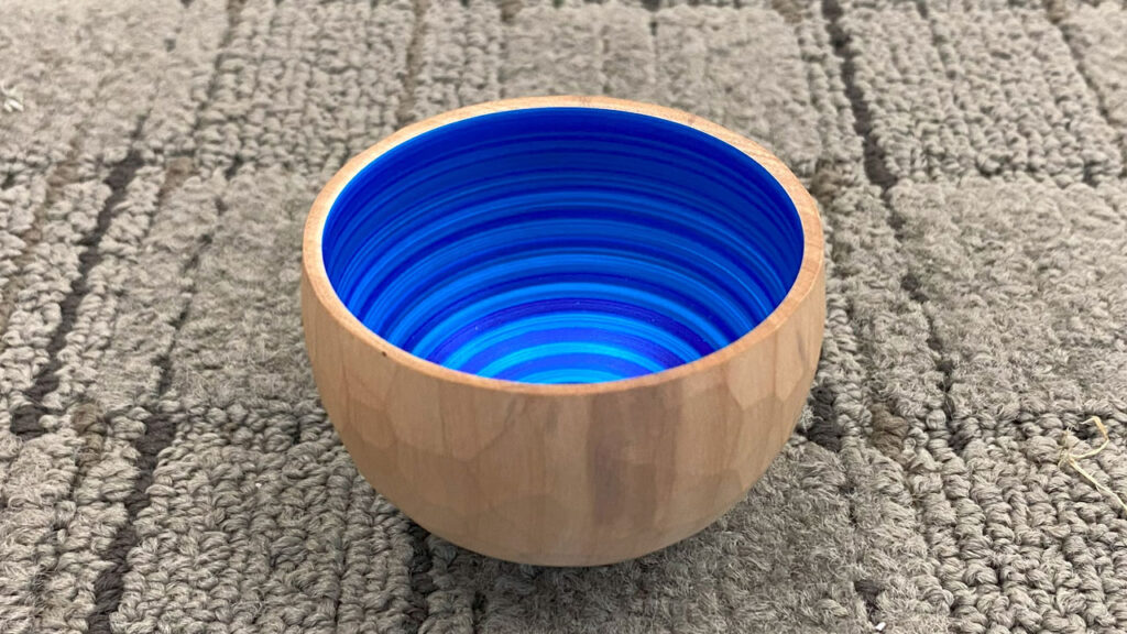 Namaste bowl with faceted walls outside and blue spiral inside by Eric Lofstrom