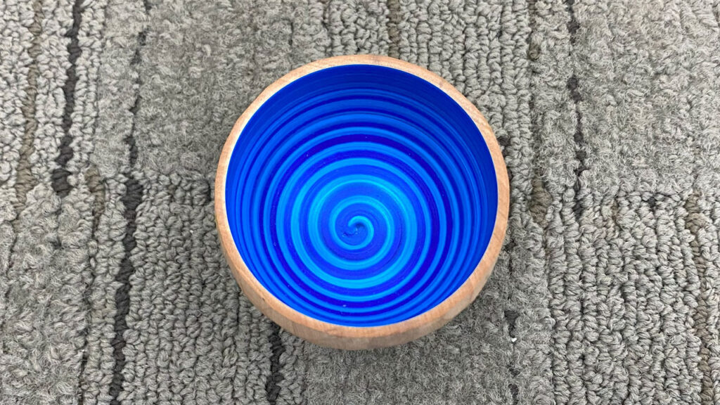 Namaste bowl with faceted walls outside and blue spiral inside by Eric Lofstrom