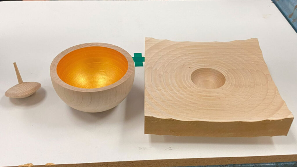 A spinning top, Namaste bowl, and Ripple bowl by Eric Lofstrom.