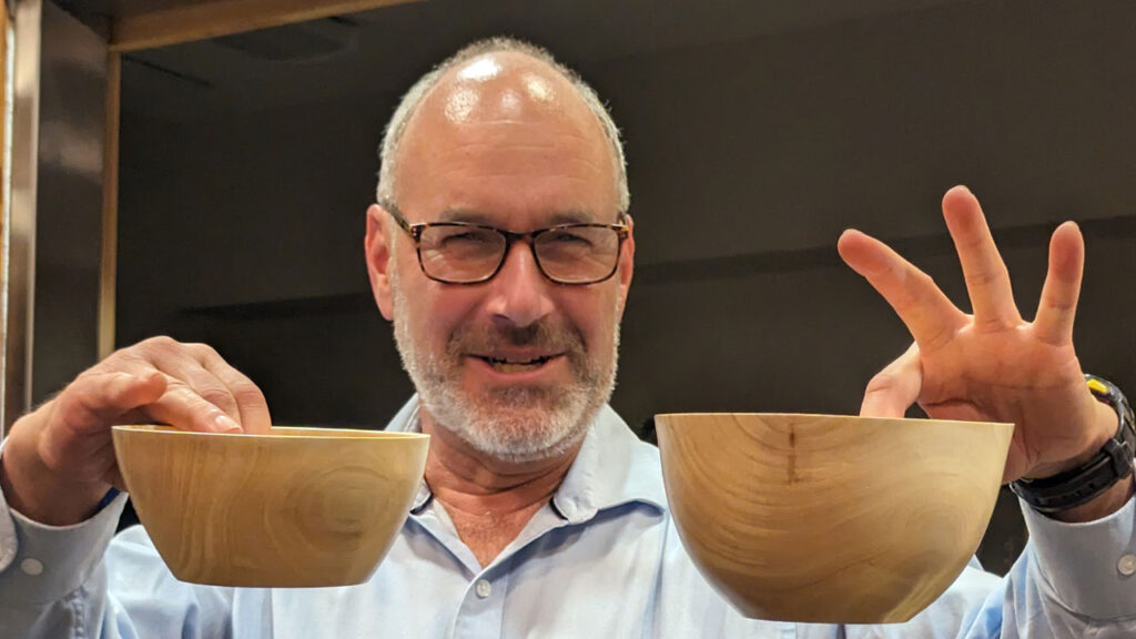 Daniel Saal shows bowls he turned from unknown wood