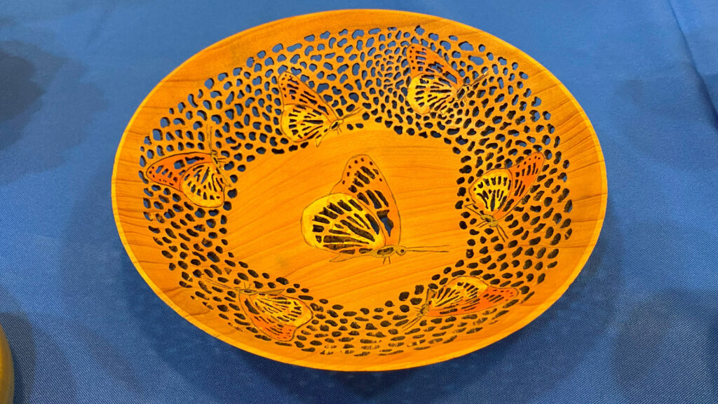 Turned and pierced bowl with butterfly decorations