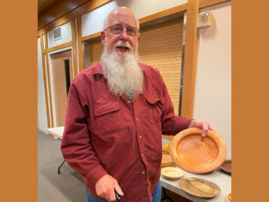 Harvey shows his woodturning project.