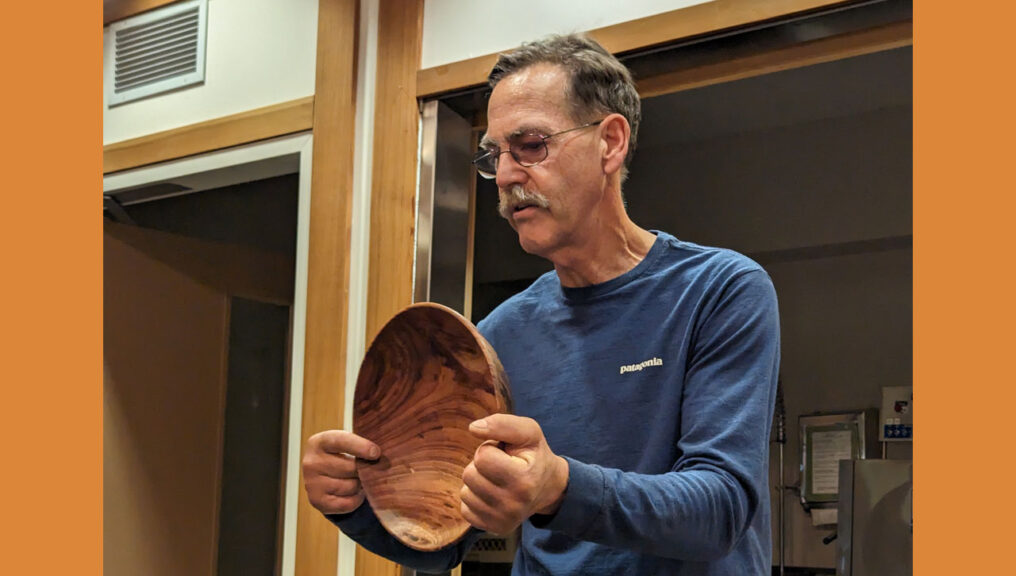 Kelly Smith shows a bowl he turned