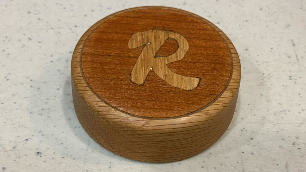 A turned fridge magnet with inlay by Laura Rhodes
