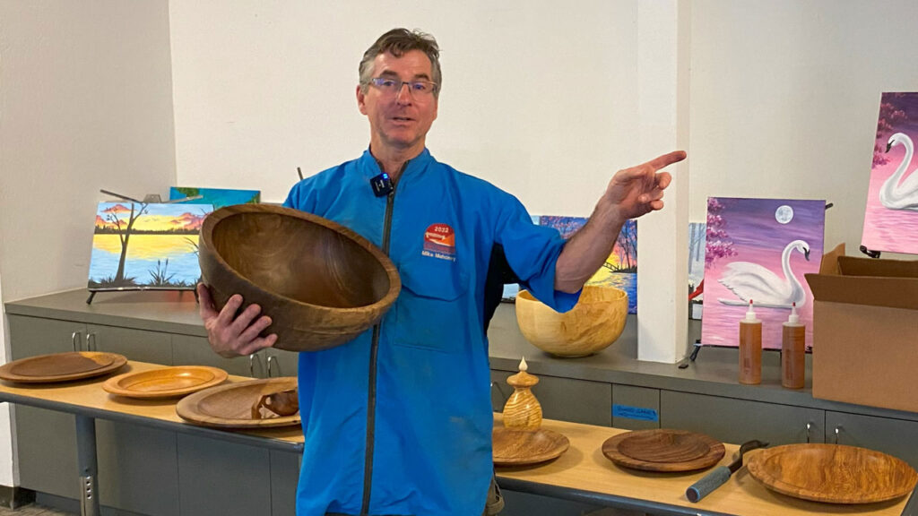 Mike Mahoney holding a large wood bowl during his woodturning demonstration in March 2024 at Maker Nexus in Sunnyvale, CA