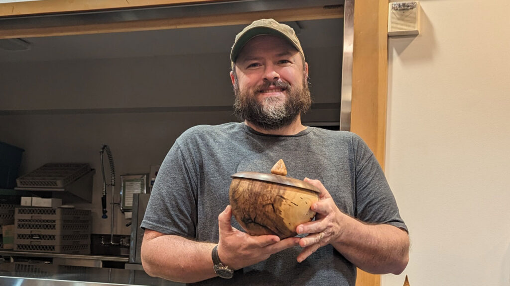 Nate Segraves shows a turned bowl with a lid