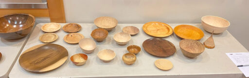 A table with thin-wall woodturned bowls and platters.
