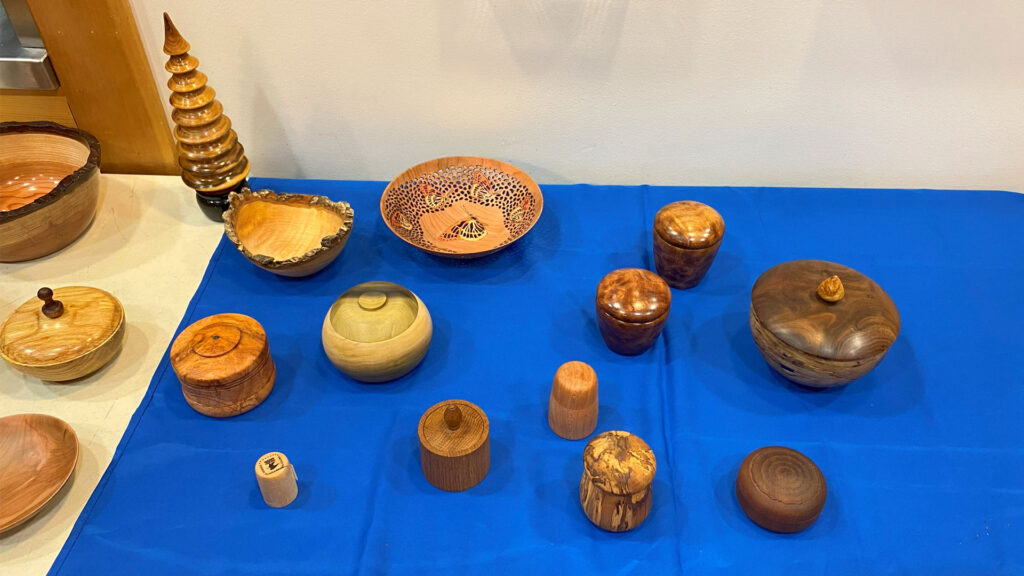 A table with many woodturning itmes: lidded box and containers