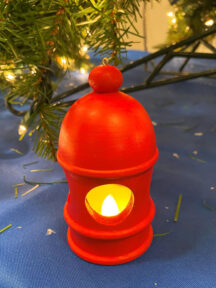 Holiday Decoration with embedded battery operated tea light. Painted red with milk paint.