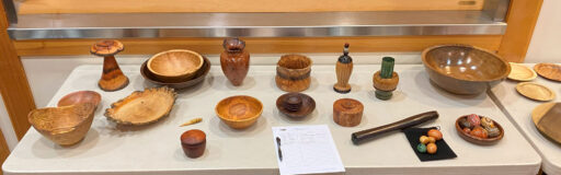 A table full of intricate woodturning projects.