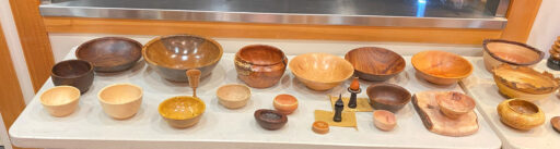 A table full of turned bowls and other items.