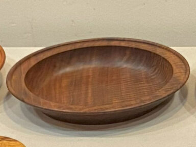 A wooden plate turned from dark wood