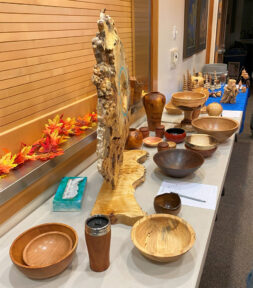 A table full of turned bowls and holiday ornaments